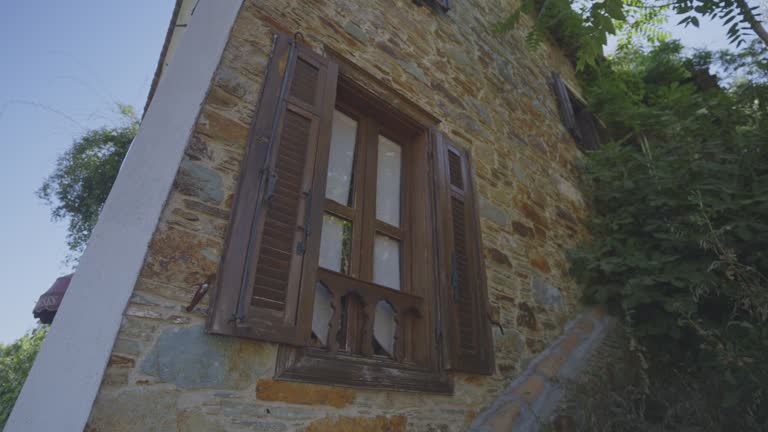 Brown wooden window in stone house in tropical village