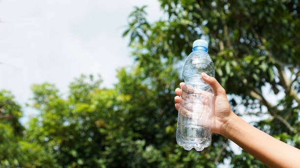 istock Hand hold plastic bottle in nature 2079727839