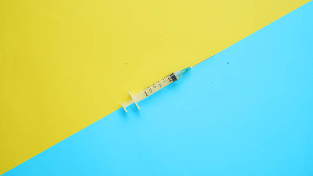 istock Single disposable plastic syringe on dual color background 2079731955