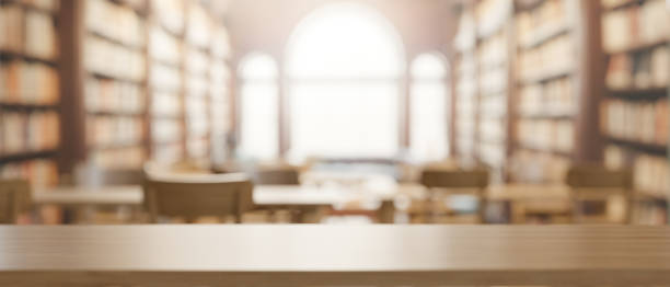 istock A presentation space on a wooden table with a blurred background of a spacious vintage library. 2079753052