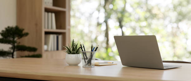 istock Back view image of a laptop computer on a wooden table in a contemporary private office. 2079760952
