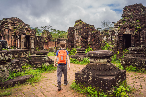Boy tourist in Temple ruin of the My Son complex, Vietnam. Vietnam opens to tourists again after quarantine Coronovirus COVID 19.