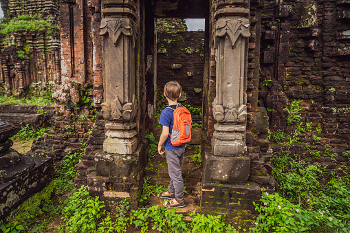 Boy tourist in Temple ruin of the My Son complex, Vietnam. Vietnam opens to tourists again after quarantine Coronovirus COVID 19.