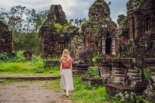 Woman tourist in Temple ruin of the My Son complex, Vietnam. Vietnam opens to tourists again after quarantine Coronovirus COVID 19.