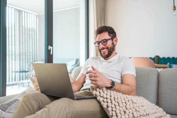 istock Cheerful Hispanic Young Adult Using Laptop Indoors 2079893869