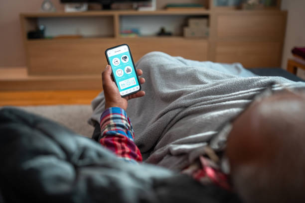 istock Ill Black Man Using Smartphone at Home 2079899046