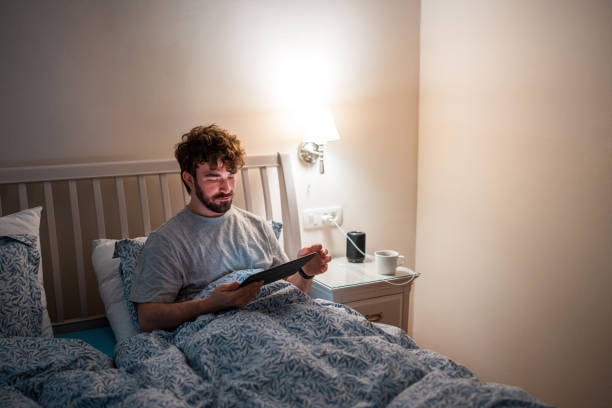 istock Caucasian Male Experiencing Sleep Disorder Using Tablet in Bed at Night 2079908462