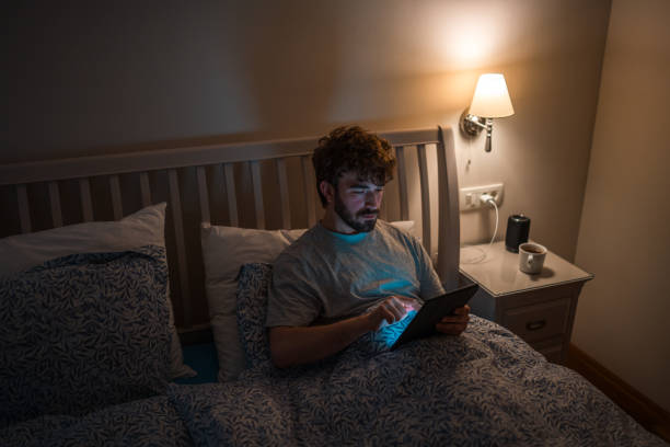 istock Caucasian Male with Sleep Disorder Using Electronic Device in Bed at Night 2079908477