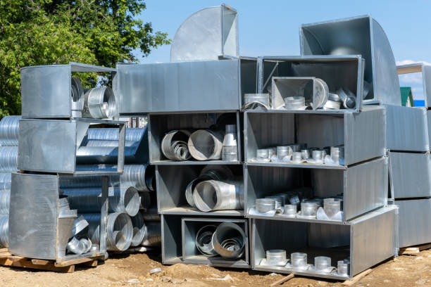 various sheet metal air ducts in stock for installation in a building under construction. ventilation pipes - air duct sheet metal construction material pipe ストックフォトと画像