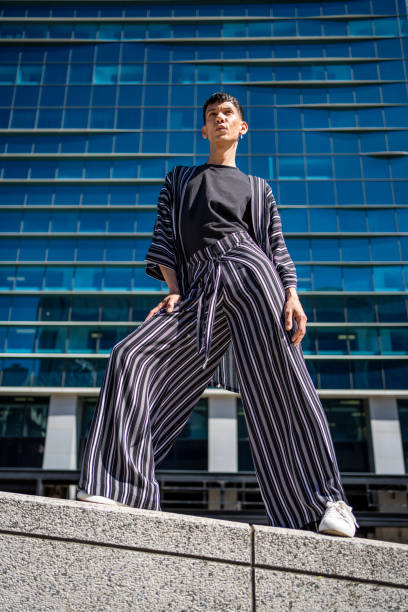 istock Stylish young model posing outside on a ledge in the city 2079940799