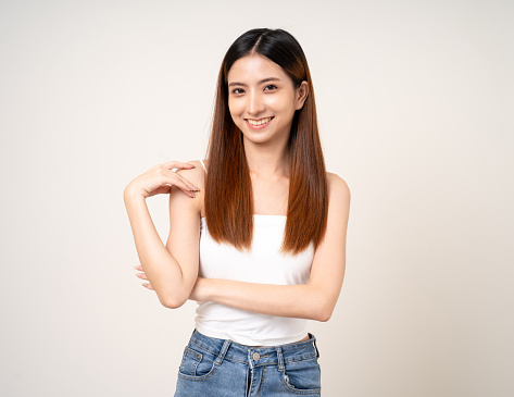 Beautiful smiling happy young asian woman age around 25. Charming female lady standing pose on isolated white background. Asian attractive woman people looking camera confident with backdrop.