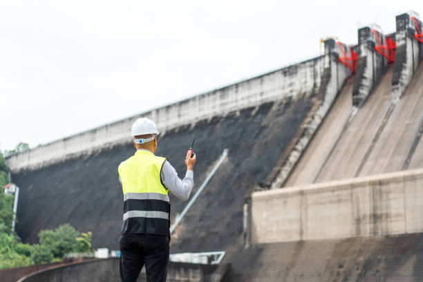 istock Professional asian maintenance engineer man with safety helmet in construction site dam with hydroelectric power plant and irrigation. Manager engineer man working at project big building. 2079964716