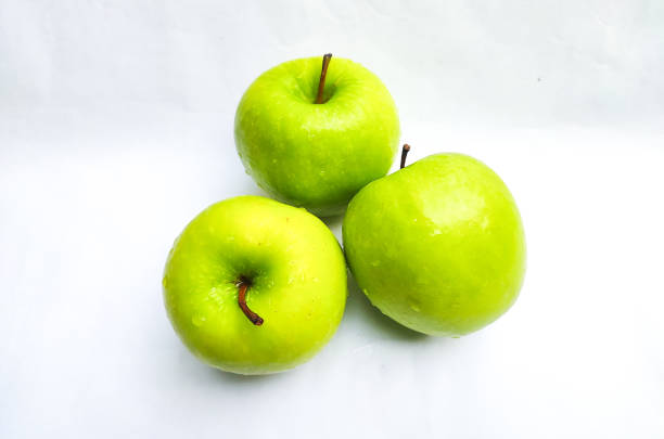 Green apple fruits isolated on white background.