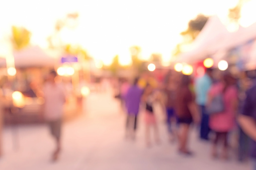crowd walking at market at sunset blur background