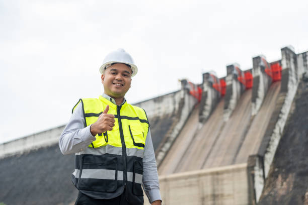 istock Professional asian maintenance engineer man with safety helmet in construction site dam with hydroelectric power plant and irrigation. Manager engineer man working at project big building. 2079986410