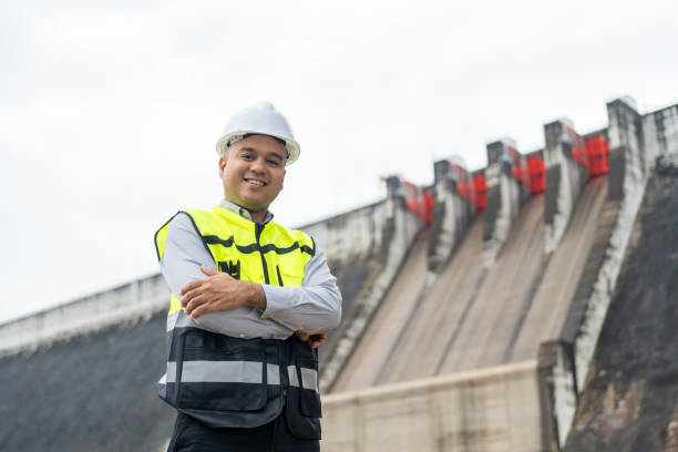 istock Professional asian maintenance engineer man with safety helmet in construction site dam with hydroelectric power plant and irrigation. Manager engineer man working at project big building. 2080001422