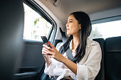 asian-woman-traveler-sitting-in-car-back-seats-using-smartphone-call-taxi-service-in.jpg?b=1&s=170x170&k=20&c=J0l4tLEF23Pgb_-6BZEkgQ2Li8OyzuVBVMqwTY6LFdo=