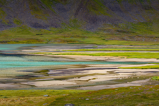 A beautiful small mountain lake in Sarek National Park, Sweden during august. Summer landscape of northern wilderness in Scandinavia.
