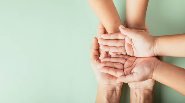 istock Parents and kid hold empty hands top view isolated. Signifying Family Day togetherness support and the legacy passed on. 2080038564