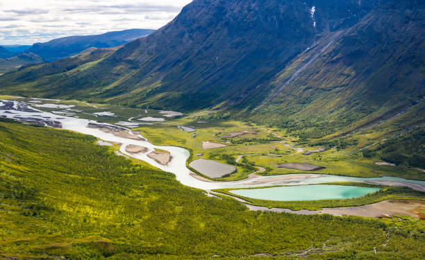 istock A beautiful Rapa river Rapadalen landscape with native plants. A mountain river from above in Sarek National Park, Sweden. 2080044348