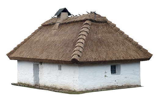 Rustic barn with thatched roof built from clay. Isolated on white