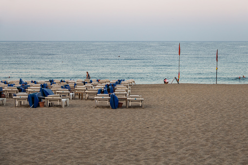 Turkey (Turkiye), Alanya, 8.09.2023: Cleopatra beach in the morning. Holidays on the Mediterranean Sea in Turkey. Sun loungers on the beach in the morning. Morning beach without people.