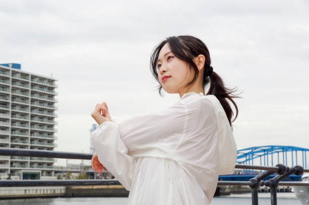 A woman doing exercises on the promenade along the river