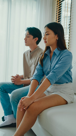Asian female psychotherapist advising couple after consult about mental health and relationship. Professional social worker assist married couples with empathy concepts. Vertical Screen.