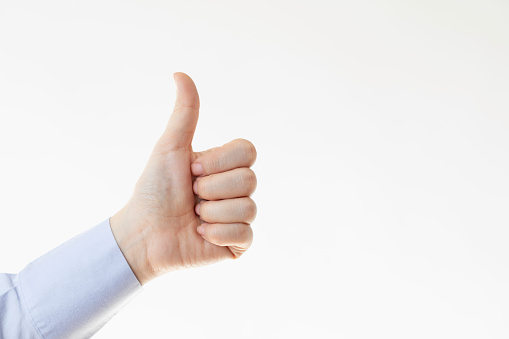 Man hand showing forefinger up and number one sign in a white isolated background