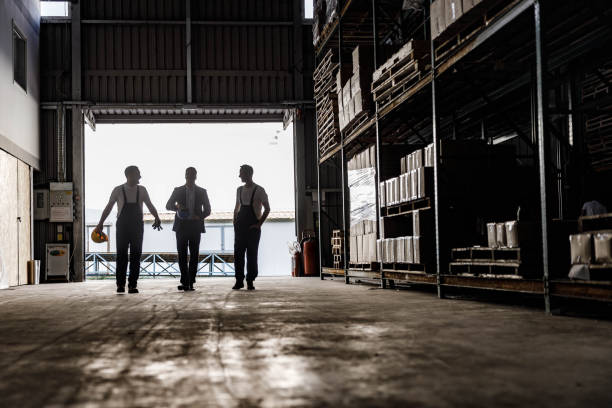 istock Happy workers and their manager talking on the move in storage room. 2080186410