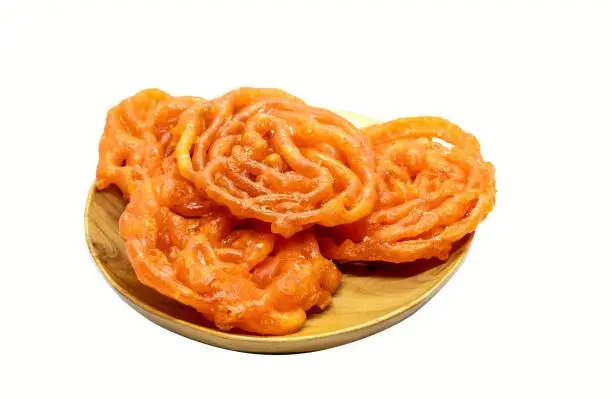 Closeup of Jilapi or Jalebi in Wooden Bowl Isolated on White Background with Copy Space, Also Known as Zalabia or Mushabak