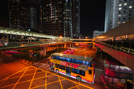 Hong Kong - July 19, 2017: Central district night street view, illuminated cityscape with buses and taxi cars