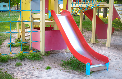 Children's playground with a red slide, perfect for outdoor recreation.
