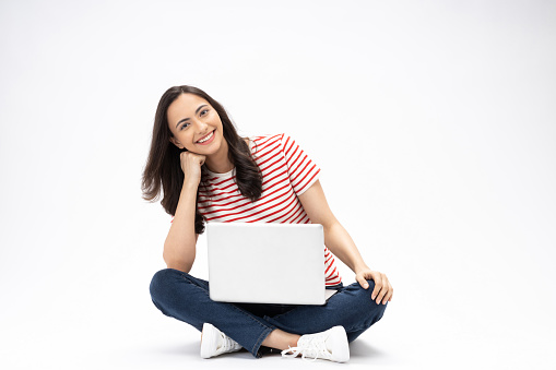 Full size photo of pretty girl sit floor netbook modern clothes isolated on white color background