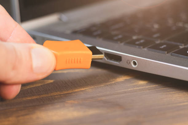 istock Man is insert the cable HDMI into the Port for information transfer. Close up, modern technology. Side panel on a laptop. Different ports for connection. 2080267928