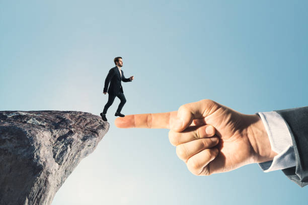 istock Businessman standing on cliff edge on bright blue sky background with finger bridge. Future, success and tomorrow concept. 2080311480