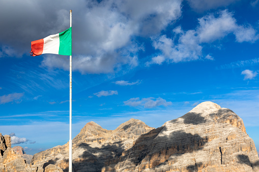 Italian flag on the summit of Langazuoi mountain, dolomites, Italy