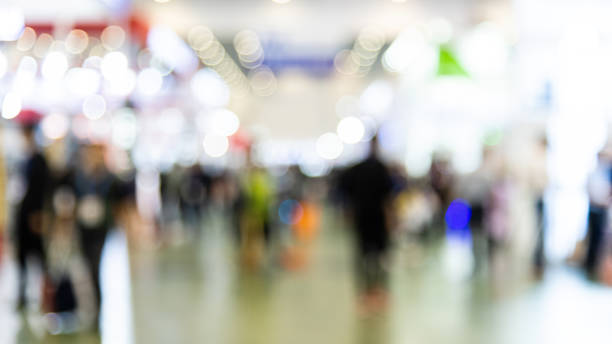 istock Abstract defocused crowd of people walking in exhibition 2080345707