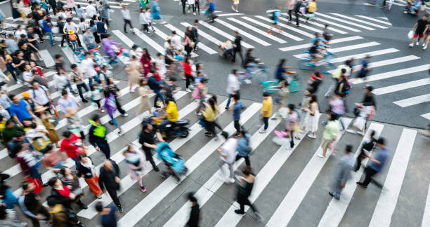 istock Motion blurred crowd of people walking on crosswalk 2080345725