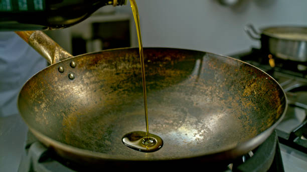 istock Oil being poured into a wok 2080391071