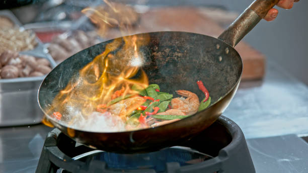 istock Preparing Stir-Fried prawns with snow peas and red capsicum in a wok 2080391583