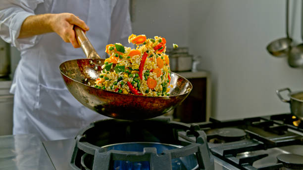 istock Chef tossing a fried rice dish in a wok 2080391620