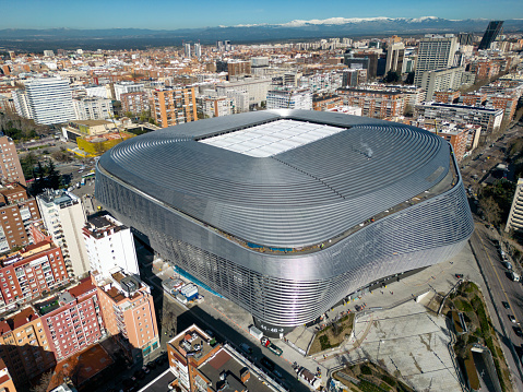 The Santiago Bernabéu Stadium continues with its renovation as seeing in this video taken in Madrid, Spain on March 12, 2024. With a seating capacity of 83,186, the stadium has the second-largest seating capacity for a football stadium in Spain. It has been the home stadium of Real Madrid since its completion in 1947. Named after footballer and legendary Real Madrid president Santiago Bernabéu (1895–1978), the stadium is one of the world's most famous football venues. The latest remodelling process began in June 2019 as soon as the season had ended. With its new wrap-around facade largely complete and its retractable roof in place, the stadium is fully operational and it is hosting La Liga matches and also international competitions such as the UEFA Champions League.