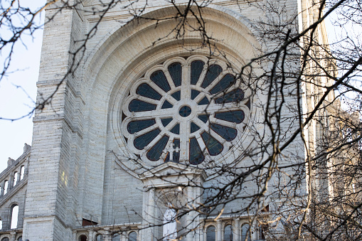 The steeple and exterior of the loyola alumni memorial chapel on the evergreen campus at Loyola University in Baltimore Maryland on a sunny blue sky day.