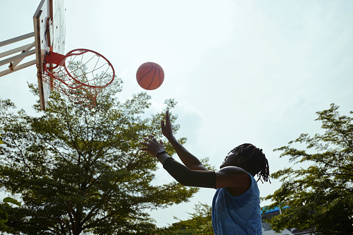 Photo of young couple playing basketball in the city.