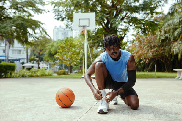 istock Streetball Player Tying Shoe Laces 2080423842