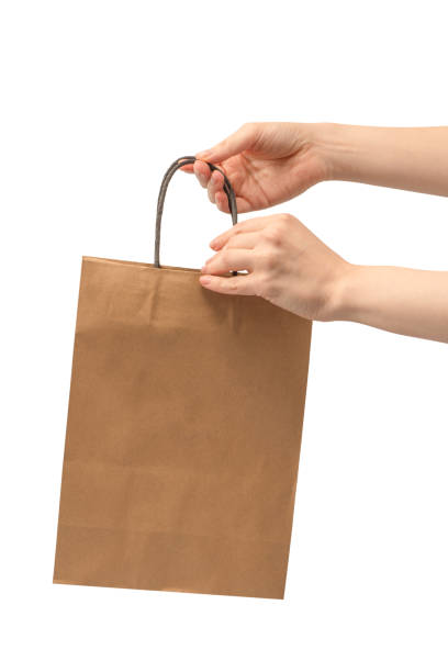 istock Paper bag in woman hand isolated on a white background. 2080437543