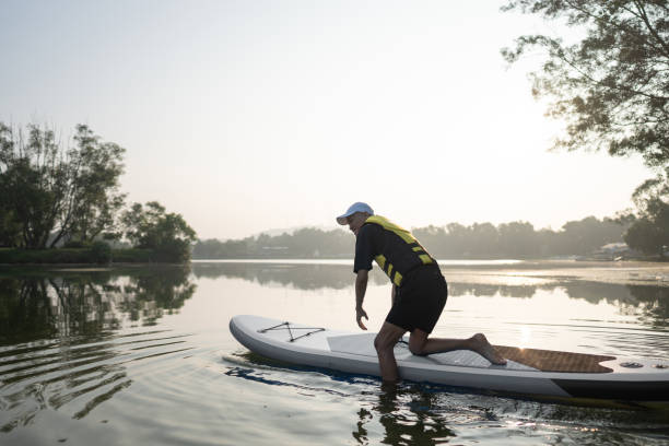 istock Standing up paddling at lake 2080451748