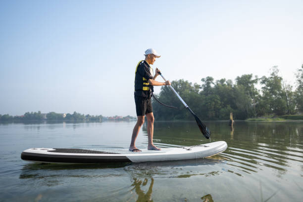 istock Standing up paddling at lake 2080452276