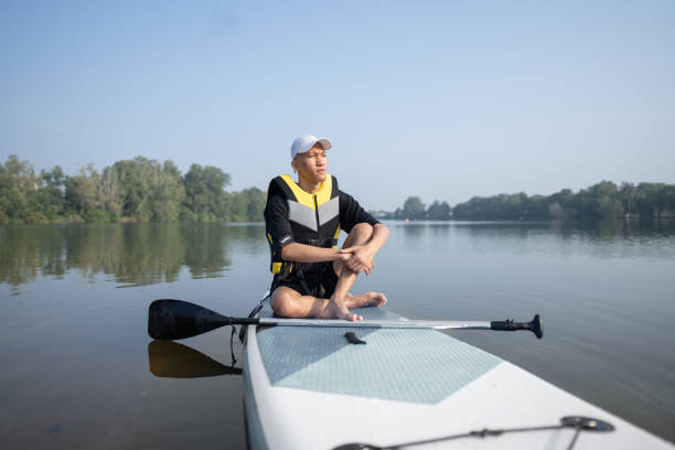 istock Standing up paddling at lake 2080454375